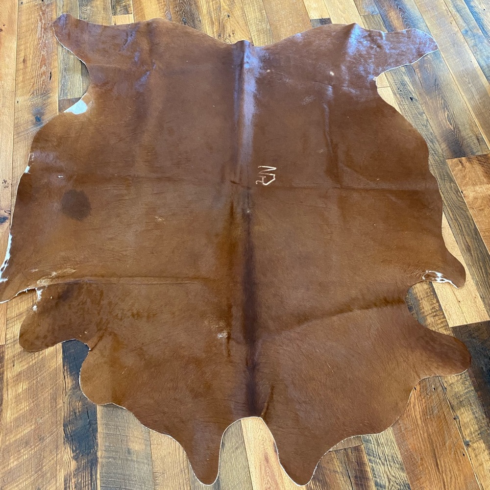 Genuine cowhide rug with brand